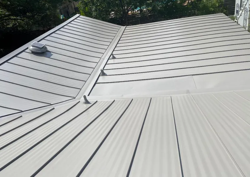 Solar attic fan installed on a metal roof for Roof Ventilation in Hondo